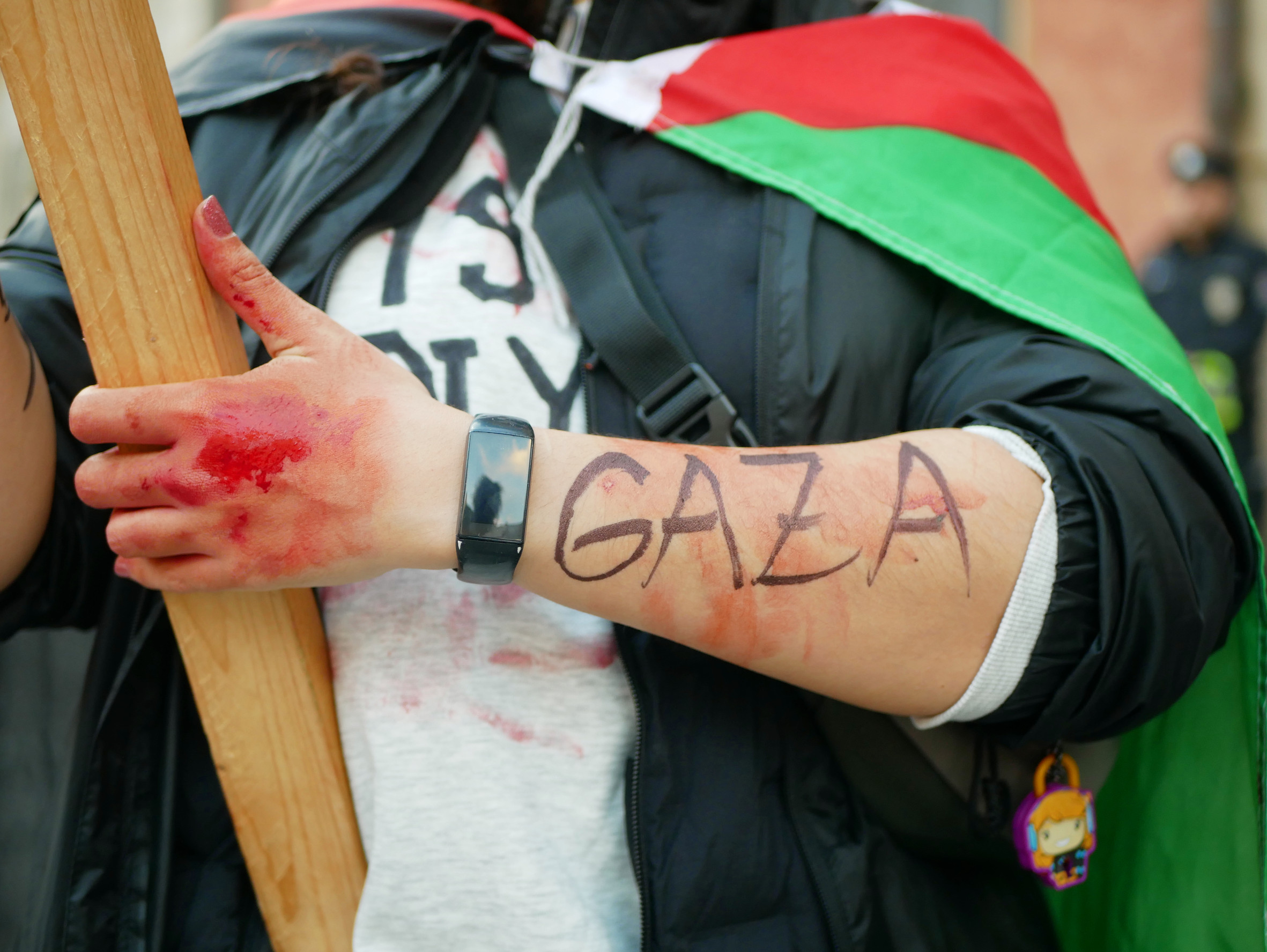 PRAGUE, CZECH REPUBLIC, NOVEMBER 1, 2023: Woman free Gaza blood hand supporters red signs flag Palestine demonstration solidarity protest Muslim slogans signs Israel Gaza war terrorism Europe gaza and autocerfa
